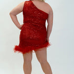 This is JK2401 in our collection Johnathan Kayne for Sydney's Closet. This plus size party dress comes in blue, red, black and white. This dress is one shoulder, all over sequins, an asymmetrical skirt, and has a feather hem.