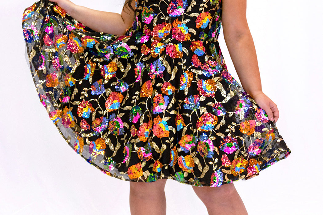 JK2501 onyx black short party dress.  Strapless, sweetheart neckline, basque waistline, pockets and flowy A-line skirt.  Unique bright colored sequin floral fabric.  Long invisible center back zipper.  Johnathan Kayne for Sydney's Closet