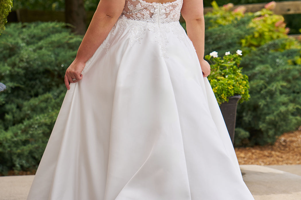 Michelle Bridal by Sydney's Closet plus size curvy wedding gowns. Floral leaf embroidery over satin on bodice on front and back. A-line skirt with pockets and long train.  Optional lining on back bodice included. Style MB2520