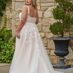 Michelle Bridal style MB2521 is available in ivory or ivory/champagne in plus sizes 14-40.  Square neckline, 1 inch illusion straps covered in leaf lace applqiues. A-line skirt with long train and optional bodice lining included.
