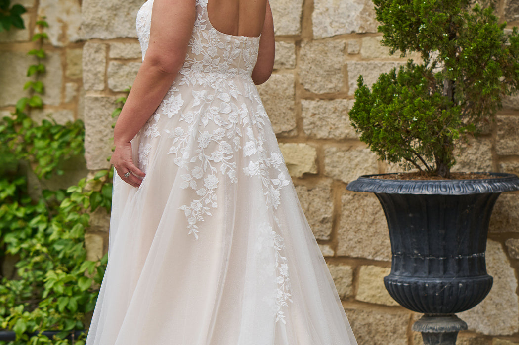Michelle Bridal style MB2521 is available in ivory or ivory/champagne in plus sizes 14-40.  Square neckline, 1 inch illusion straps covered in leaf lace applqiues. A-line skirt with long train and optional bodice lining included.
