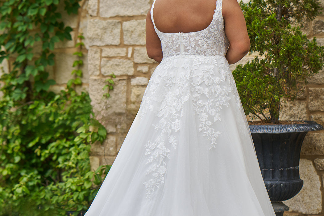 Michelle Bridal style MB2521 is available in ivory or ivory/champagne in plus sizes 14-40.  Square neckline, 1 inch illusion straps covered in leaf lace applqiues. A-line skirt with long train and optional bodice lining included.