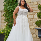 Michelle Bridal style MB2521 is available in ivory or ivory/champagne in plus sizes 14-40.  Square neckline, 1 inch illusion straps covered in leaf lace applqiues. A-line skirt with long train and optional bodice lining included.