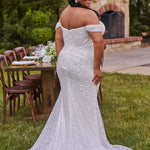 Sexy curvy plus-size fitted formal bridal dress with drape sleeves, exposed boning and ruching.  Beaded bling fabric with sequins, stones and pearls.  Long train and ruching on the buttocks. MB2528 from Michelle Bridal by Sydney's Closet.