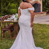 Sexy curvy plus-size fitted formal bridal dress with drape sleeves, exposed boning and ruching.  Beaded bling fabric with sequins, stones and pearls.  Long train and ruching on the buttocks. MB2528 from Michelle Bridal by Sydney's Closet.