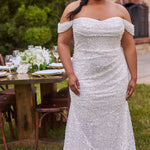 Sexy curvy plus-size fitted formal bridal dress with drape sleeves, exposed boning and ruching.  Beaded bling fabric with sequins, stones and pearls.  Long train and ruching on the buttocks. MB2528 from Michelle Bridal by Sydney's Closet.