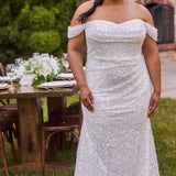 Sexy curvy plus-size fitted formal bridal dress with drape sleeves, exposed boning and ruching.  Beaded bling fabric with sequins, stones and pearls.  Long train and ruching on the buttocks. MB2528 from Michelle Bridal by Sydney's Closet.