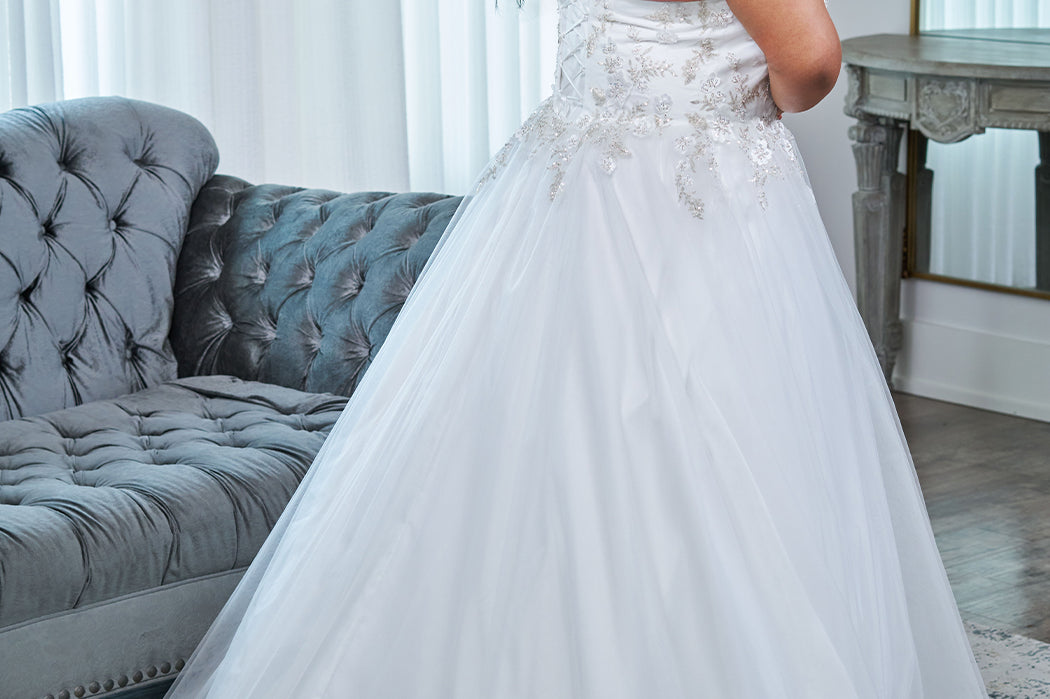 Sydney's Closet plus size wedding dress with lace up back and modesty panel.  V-neckline embelished with 3D floral appliques and silver stones.  Full A-line skirt and long train. Style SC5345