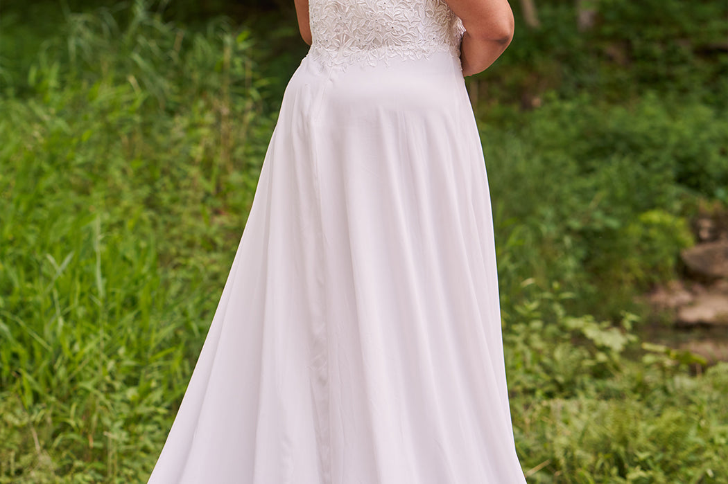 Sydney's Closet plus size wedding dress with sweetheart neckline,spaghetti straps and flowing chiffon skirt with slit. Lace covered bodice comes unlined with optional lining included. Style SC5348 is avialable in ivory