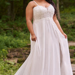 Sydney's Closet plus size wedding dress with sweetheart neckline,spaghetti straps and flowing chiffon skirt with slit. Lace covered bodice comes unlined with optional lining included. Style SC5348 is avialable in ivory