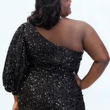 This is SC8133 in our Sydney's Closet Homecoming collection. This plus size party dress comes in black, blue, purple, and red! This dress has a one shoulder long sleeve pouf sleeve, a cutout bodice, and a natural waistline. This fitted all over sequin dress has the spotlight as the most perfect dress for this homecoming season!