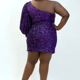 This is SC8133 in our Sydney's Closet Homecoming collection. This plus size party dress comes in black, blue, purple, and red! This dress has a one shoulder long sleeve pouf sleeve, a cutout bodice, and a natural waistline. This fitted all over sequin dress has the spotlight as the most perfect dress for this homecoming season!