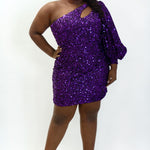 This is SC8133 in our Sydney's Closet Homecoming collection. This plus size party dress comes in black, blue, purple, and red! This dress has a one shoulder long sleeve pouf sleeve, a cutout bodice, and a natural waistline. This fitted all over sequin dress has the spotlight as the most perfect dress for this homecoming season!