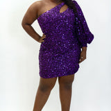 This is SC8133 in our Sydney's Closet Homecoming collection. This plus size party dress comes in black, blue, purple, and red! This dress has a one shoulder long sleeve pouf sleeve, a cutout bodice, and a natural waistline. This fitted all over sequin dress has the spotlight as the most perfect dress for this homecoming season!