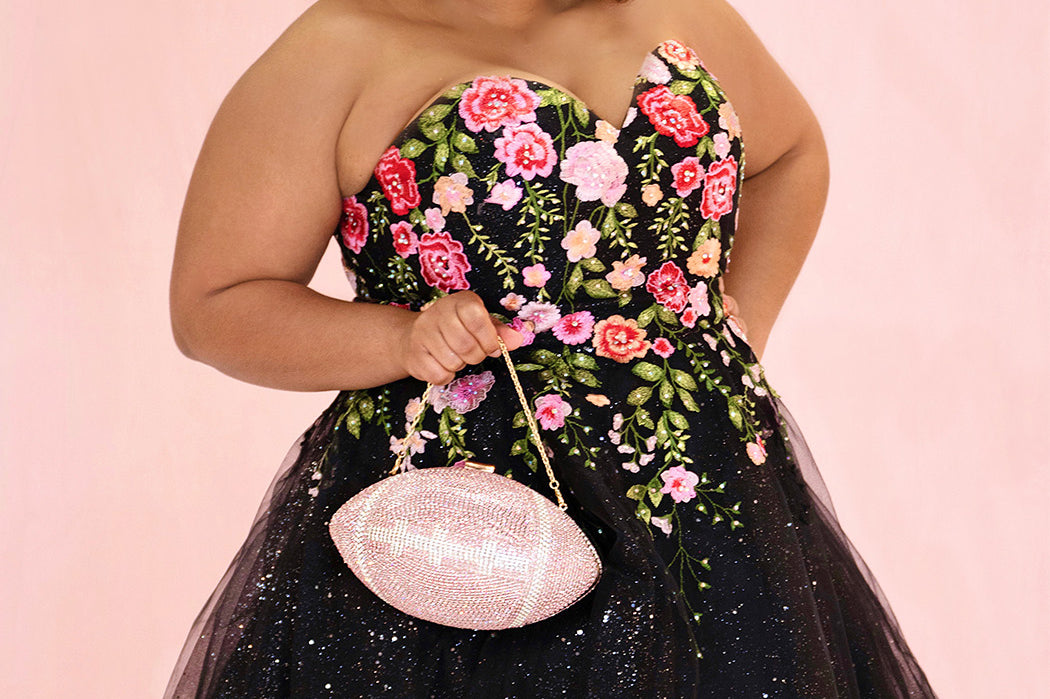 SC8137 Front view. Black sparkle tulle short a-line party dress with pink floral embroidered roses. Strapless sweetheart neckline, long invisible center back zipper.  Available only in black floral. Curvy sizes 10-32. Model in picture is 5 foot 9 inches and a size 16.