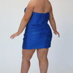 Short fitted royal blue party dress SC8143 by Sydney's Closet. Back view.  Strapless, exposed boning basque waist and ruched fitted skirt in shimmer stretch knit. Long invisible center back zipper. Availability in black, purple, red, ivory, green and royal. Model in picture is 5'9.