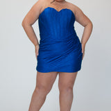 Short fitted royal blue party dress SC8143 by Sydney's Closet. Front view.  Strapless, exposed boning basque waist and ruched fitted skirt in shimmer stretch knit. Long invisible center back zipper. Availability in black, purple, red, ivory, green and royal. Model in picture is 5'9.