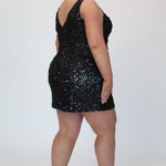 Short fitted Onyx black party dress SC8145 by Sydney's Closet. Back view.  Fully sequined short gown, with 3D floral embellishments on bodice. Thick bra-friendly straps, deep v-neckline. Long invisible center back zipper. Availability in lilac purple, onyx black and ruby red . Model in picture is 5'9.