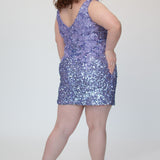 Short fitted lilac purple party dress SC8145 by Sydney's Closet. Back view.  Fully sequined short gown, with 3D floral embellishments on bodice. Thick bra-friendly straps, deep v-neckline. Long invisible center back zipper. Availability in lilac purple, onyx black and ruby red . Model in picture is 5'9.