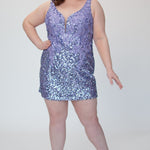 Short fitted lilac purple party dress SC8145 by Sydney's Closet. Front view.  Fully sequined short gown, with 3D floral embellishments on bodice. Thick bra-friendly straps, deep v-neckline. Long invisible center back zipper. Availability in lilac purple, onyx black and ruby red . Model in picture is 5'9.