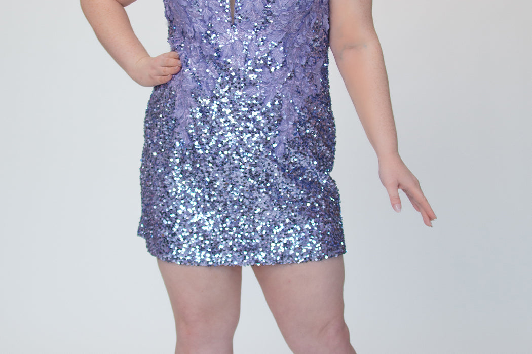 Short fitted lilac purple party dress SC8145 by Sydney's Closet. Front view.  Fully sequined short gown, with 3D floral embellishments on bodice. Thick bra-friendly straps, deep v-neckline. Long invisible center back zipper. Availability in lilac purple, onyx black and ruby red . Model in picture is 5'9.