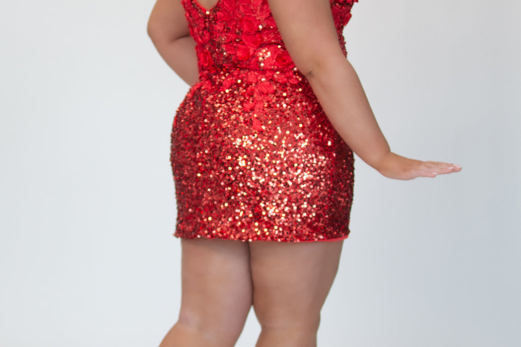 Short fitted Ruby red party dress SC8145 by Sydney's Closet. Back view.  Fully sequined short gown, with 3D floral embellishments on bodice. Thick bra-friendly straps, deep v-neckline. Long invisible center back zipper. Availability in lilac purple, onyx black and ruby red . Model in picture is 5'9.