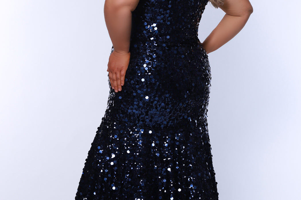 Fitted mermaid plus size prom dress.  Sequin and piette fabric with stretch knit linight. Deep v-neckline with nude mesh insert and spaghetti straps. Mermaid fitted skirt. Available in midnight navy blue and hot magenta pink. TE2512 by Tease Prom.