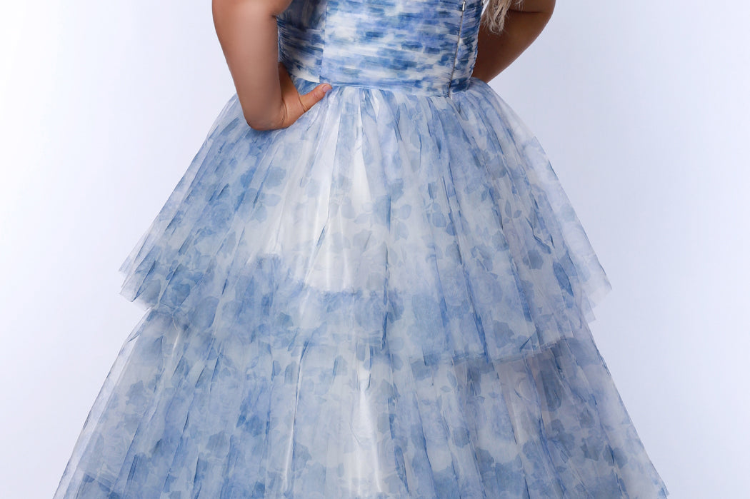 Best selling plus size floral tiered ballgown dress style TE2525 by Tease Prom.  Double spaghetti straps on pleated V-neckline bodice with tiered ball gown skirt in floral print tulle. Available in black floral or blue floral in sizes 14-32.