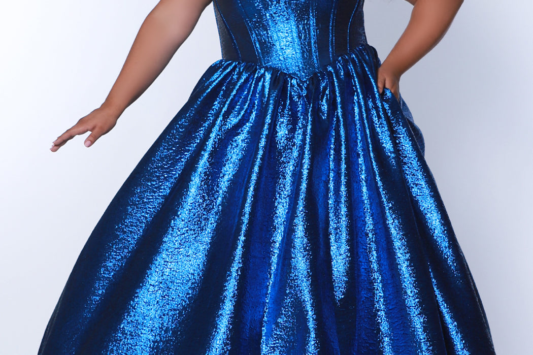 Tease Prom for Sydney's Closet style TE2539 available in ruby red or sapphire blue. Plus size ballgown with strapless sweetheart bodice, exposed boning, basque waist and full A-line skirt with pockets.