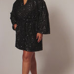 Our plus size sequin robe is a stunning, comfortable piece designed for confident, curvy women looking for comfort as they get ready on their special day. Made from stretch sequin with a light stretch knit lining, this robe is the perfect getting ready outfit  Roomy sleeves and an adjustable tie belt make for the perfect fit and pockets to hold your essentials! Style SC1009 by Sydney's Closet - Onyx Black Video on Set