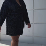Our plus size sequin robe is a stunning, comfortable piece designed for confident, curvy women looking for comfort as they get ready on their special day. Made from stretch sequin with a light stretch knit lining, this robe is the perfect getting ready outfit  Roomy sleeves and an adjustable tie belt make for the perfect fit and pockets to hold your essentials! Style SC1009 by Sydney's Closet - Onyx Black Video outside of studio