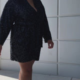 Our plus size sequin robe is a stunning, comfortable piece designed for confident, curvy women looking for comfort as they get ready on their special day. Made from stretch sequin with a light stretch knit lining, this robe is the perfect getting ready outfit  Roomy sleeves and an adjustable tie belt make for the perfect fit and pockets to hold your essentials! Style SC1009 by Sydney's Closet - Onyx Black Video outside of studio