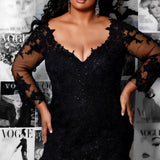 Michelle Bridal MB2202 Editorial shot of model in black fitted mermaid dress with v-neckline with black lace on bodice and sleeves.