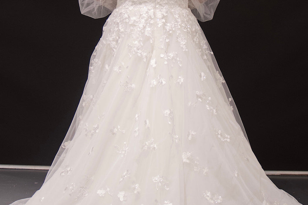 Michelle Bridal MB2308 Ivory. Soft bridal tulle, 3D floral lace appliques, A-line silhouette, Scoop neckline, Detachable pouf sleeve with lace and zipper on cuff included, Scoop back, Long invisible center back zipper, Full A-line skirt with 3D lace appliques on front and back.
