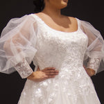 Michelle Bridal MB2308 Ivory. Soft bridal tulle, 3D floral lace appliques, A-line silhouette, Scoop neckline, Detachable pouf sleeve with lace and zipper on cuff included, Scoop back, Long invisible center back zipper, Full A-line skirt with 3D lace appliques on front and back.