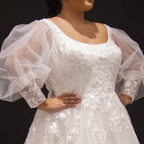 Michelle Bridal MB2308 Ivory. Soft bridal tulle, 3D floral lace appliques, A-line silhouette, Scoop neckline, Detachable pouf sleeve with lace and zipper on cuff included, Scoop back, Long invisible center back zipper, Full A-line skirt with 3D lace appliques on front and back.
