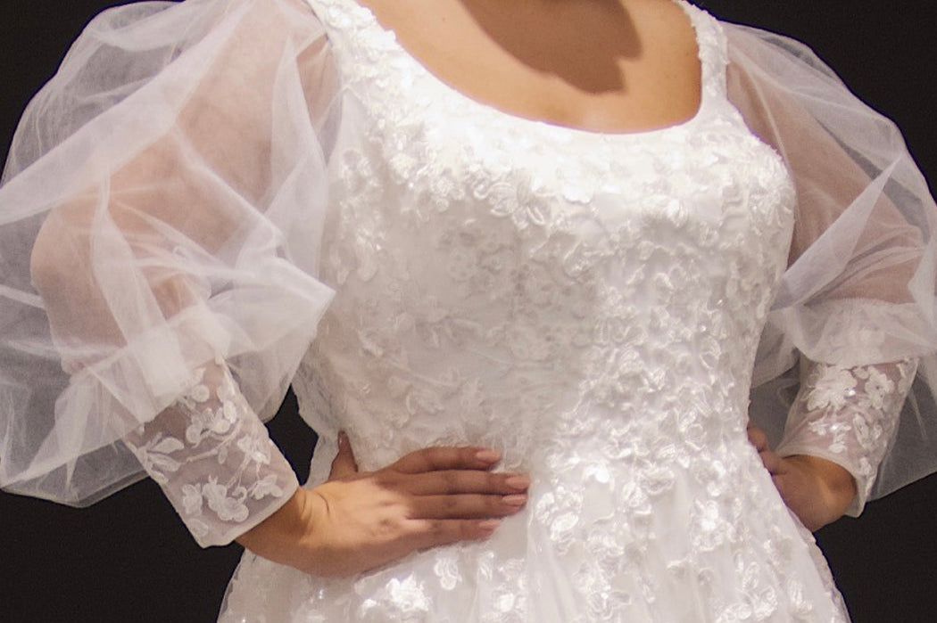 Michelle Bridal MB2308 Ivory. Soft bridal tulle, 3D floral lace appliques, A-line silhouette, Scoop neckline, Detachable pouf sleeve with lace and zipper on cuff included, Scoop back, Long invisible center back zipper, Full A-line skirt with 3D lace appliques on front and back.
