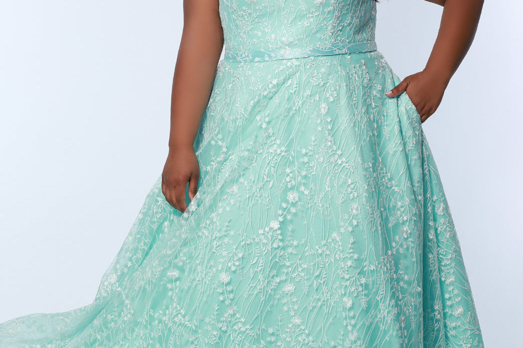 Tease Prom TE2314 Mint Green.  Fully lined, A-line silhouette, natural waistline  and V-neckline.Ball gown skirt with pockets. Tulle with leaf lace appliques with hot fix stones. Half inch straps covered in lace. Long invisible center back zipper and a detachable self belt. 