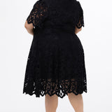 Plus size little black dress made of Guipure lace. Cap sleeves, scoop neckline and center back zipper. CE2601 available in sizes 14-24 in black. Celebrations by Sydney's Closet.