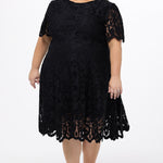 Plus size little black dress made of Guipure lace. Cap sleeves, scoop neckline and center back zipper. CE2601 available in sizes 14-24 in black. Celebrations by Sydney's Closet.
