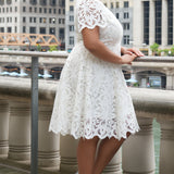 LWD style CE2601 in white. Scoop neckline, short sleeve, scalloed hem on sleeves and hem of dress. Princess silohuette, pockets and elegant Guipere lace. Long invisible center back zipper.  Celebrations by Sydney's Closet