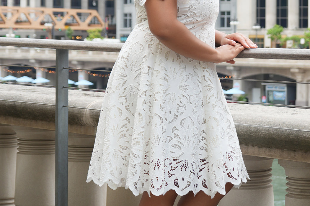 LWD style CE2601 in white. Scoop neckline, short sleeve, scalloed hem on sleeves and hem of dress. Princess silohuette, pockets and elegant Guipere lace. Long invisible center back zipper.  Celebrations by Sydney's Closet