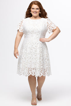 LWD style CE2601 in white. Scoop neckline, short sleeve, scalloed hem on sleeves and hem of dress. Princess silohuette, pockets and elegant Guipere lace. Long invisible center back zipper.  Celebrations by Sydney's Closet
