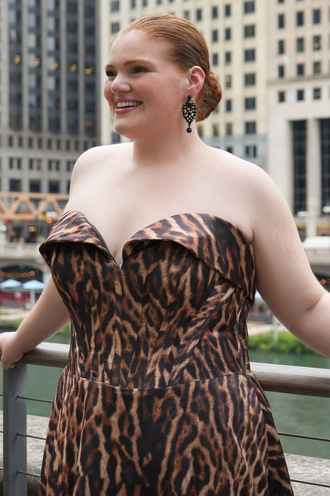 Plus size Tee length animal print dress.  fold over cuff detail, exposed corset boning, natural waistline, and A-line skirt with pockets and center back zipper. CE2603 available in sizes 14-24 in animal print. Celebrations by Sydney's Closet. 
