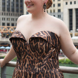 Plus size Tee length animal print dress.  fold over cuff detail, exposed corset boning, natural waistline, and A-line skirt with pockets and center back zipper. CE2603 available in sizes 14-24 in animal print. Celebrations by Sydney's Closet. 
