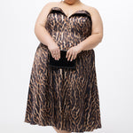 Plus size Tee length animal print dress.  fold over cuff detail, exposed corset boning, natural waistline, and A-line skirt with pockets and center back zipper. CE2603 available in sizes 14-24 in animal print. Celebrations by Sydney's Closet.