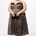 Plus size Tee length animal print dress.  fold over cuff detail, exposed corset boning, natural waistline, and A-line skirt with pockets and center back zipper. CE2603 available in sizes 14-24 in animal print. Celebrations by Sydney's Closet.