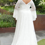 Boho crochet lace plus size wedding dress with V-neckline, illusion lace straps, illusion long flowy bell sleeves, natural wiasltine and slim A-line skirt finished with scalloped eyelash hem.  Available in ivory. Celebrations by Sydney's Closet style CE2604