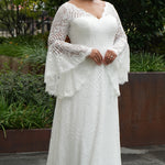 Boho crochet lace plus size wedding dress with V-neckline, illusion lace straps, illusion long flowy bell sleeves, natural waistline and slim A-line skirt finished with scalloped eyelash hem.  Available in ivory. Celebrations by Sydney's Closet style CE2604