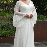 Boho crochet lace plus size wedding dress with V-neckline, illusion lace straps, illusion long flowy bell sleeves, natural waistline and slim A-line skirt finished with scalloped eyelash hem.  Available in ivory. Celebrations by Sydney's Closet style CE2604